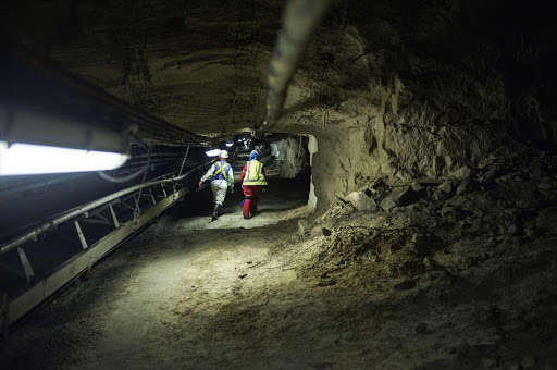 Two women miners walk through a tunnel at the end of their shift at the Anglo American Bathopele Mine in Rustenburg. File photo.