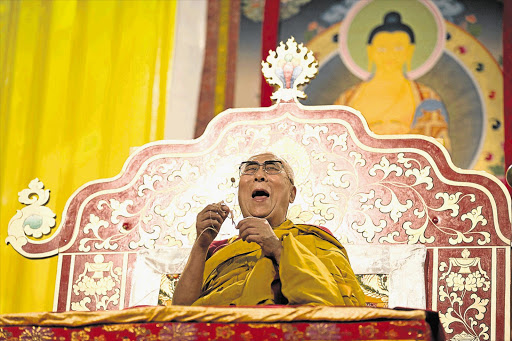 GOOD KARMA: Tibetan spiritual leader the Dalai Lama at a lecture in Hamburg on the last day of his visit to Germany Picture: CHRISTIAN CHARISIUS/AFP