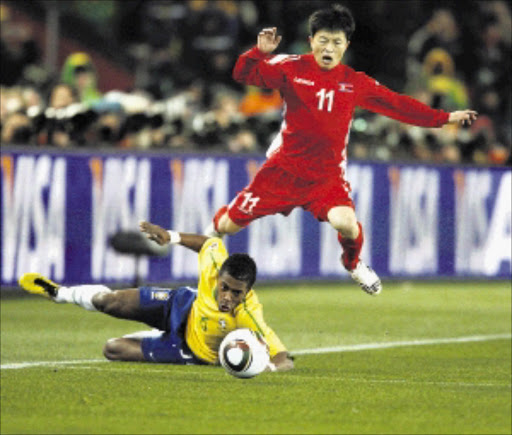 WALTZ: North Korea's Mun In-Guk dribbles past Brazil's Michel Bastos in their World Cup match at Ellis Park last night. Brazil won 2-1. PHOTO: ANTONIO MUCHAVE. 15/06/2010. © Sowetan.