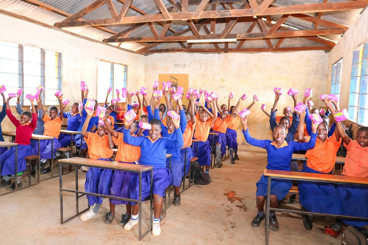 Girls at Gimba Primary school in Taita Taveta receive sanitary pads after a mentorship program by DMF.