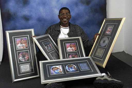 Tshanda with gold and platinum plaques he and his company have been awarded over the years./ MOTLAPELE TAU