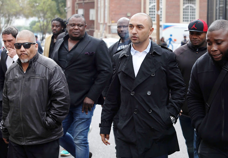 Alleged underworld boss Nafiz Modack outside Cape Town regional court with bodyguards earlier in his trial.