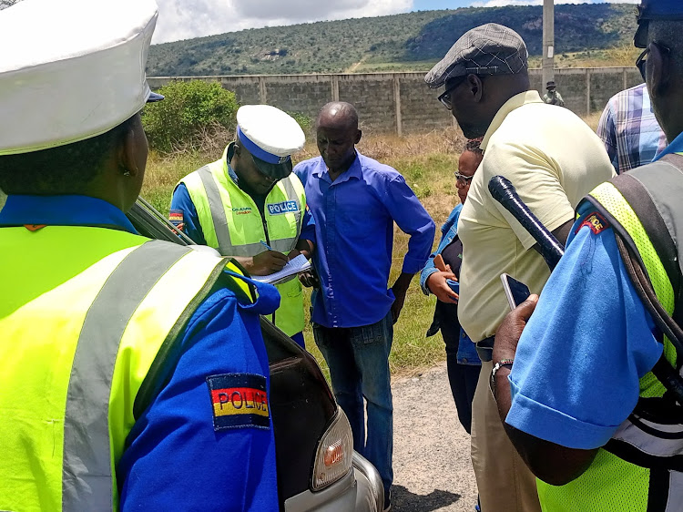 Motorists are booked by police for traffic offences during a multiagency road safety compliance checks on Nairobi-Mombasa highway on March 27, 2024.