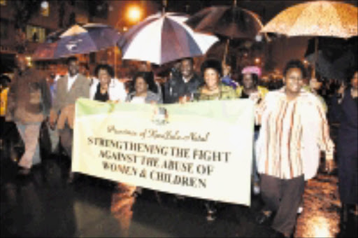 ON THE MARCH: From right, Lungi Gcabashe, MEC for health, Peggy Nkonyeni, MEC for public works, Lydia Johnson and MEC for arts, culture and tourism, Weziwe Thusi, joined the march against women and child abuse on Friday night in Durban. 07/11/08. Pic. Thuli Dlamini. © Sowetan.
