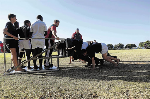BOYS IN TRAINING: Border rugby stars Blake Kyd and Johannes Jonker put the Border U13 forwards through a tough training session at Gonubie Primary school in preparation for the U13 tournament scheduled for Paarl early next month Picture: SIBONGILE NGALWA