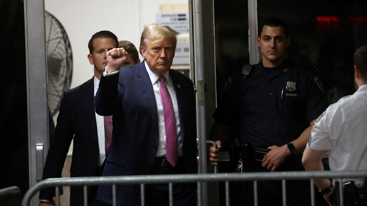 Former US President Donald Trump enters the Manhattan Criminal Court after a lunch break during his trial for allegedly covering up hush money payments on April 19 2024 in New York City. Trump faces 34 felony counts of falsifying business records in the first of his criminal cases to go to trial.