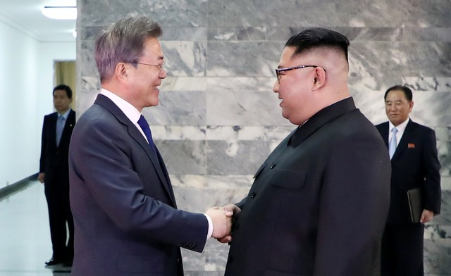 South Korean President Moon Jae-in shakes hands with North Korean leader Kim Jong Un during their summit at the truce village of Panmunjom, North Korea, in this handout picture provided by the Presidential Blue House on May 26, 2018.