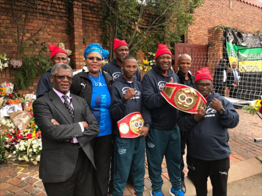 Team Zolani Tete and BSA board chairman Peter Ngatane and MEC for sport, recreation, arts and culture Pemmy Majodina outside Mama Winnie Mandela's home in Soweto where Tete went to pay condolences and get blessing ahead of his title defense next Saturday Picture: SUPPLIED