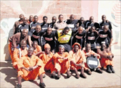TEAM SPIRIT: Inmates of Johannesburg Prison show off their new Pirates strip. Pic. Nthabiseng Moreosele. 13/08/08. © Sowetan.