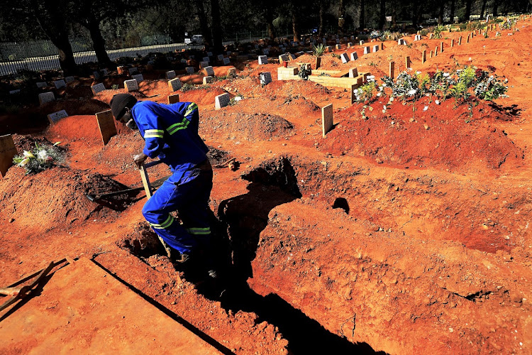 A digger prepares a grave for a Covid-19 victim at Wespark Cemetery in Johannesburg.
