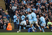 Jeremy Doku celebrates scoring Manchester City's fourth goal with teammates in their Premier League win against Luton Town at Etihad Stadium in Manchester on Saturday.