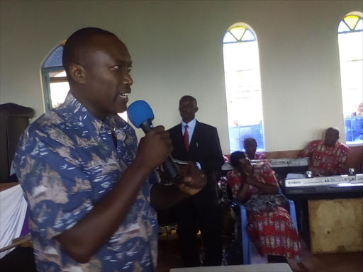 Kathaini MP Robert Mbui addresses a congregation at Kasaini ABC Church on Sunday when he attended the new opening of the church. Mbui told the locals not to expect much from the Jubilee Government. Pix Andrew Mbuva