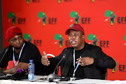  EFF Deputy Presint, Floyd shivambu looks on as Commander in Chief, Julius Malema addresses the media at the IEC results centre  about the outcomes of the local government elections.