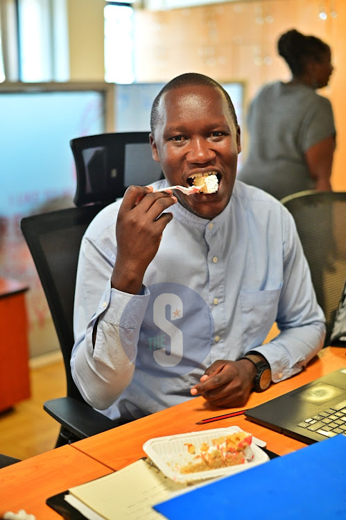 Radio Africa Group Events Executive Andrew Lucheli eating a piece of cake.