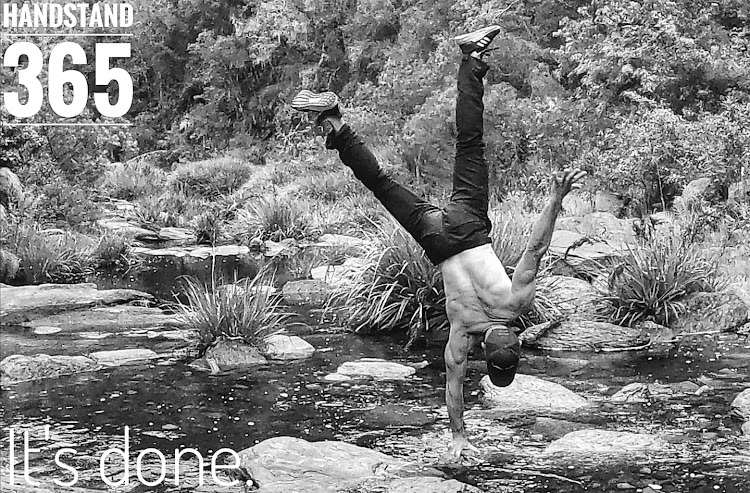 Jeff Ayliffe completes handstand no 365 on December 31 2019, supporting himself on one hand in the middle of a river off the Seven Passes Road near Wilderness in the Western Cape.