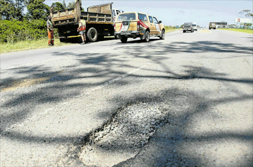 DEEP DANGER: The large pothole that left many vehicles damaged on Voortrekker Road (R102) in Wilsonia, in front of J & J Picture: MICHAEL PINYANA