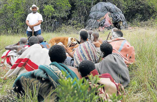SAFETY FIRST: Chief whip of the Buffalo City Metro traditional leaders Chief Stanley Makinana talks to some of the boys found at an illegal initiation school in Amalinda Picture ALAN EASON