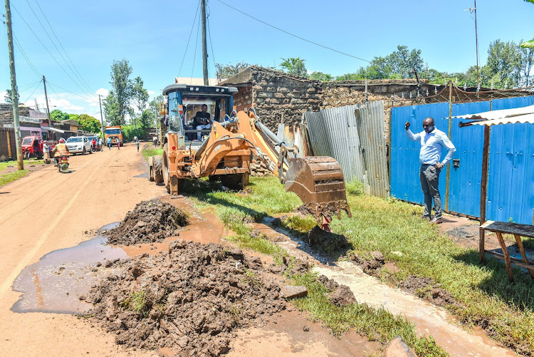 Kirinyaga County government officials clean the drainage system to enhance runoff water flow and prevent flooding, on April 18, 2024