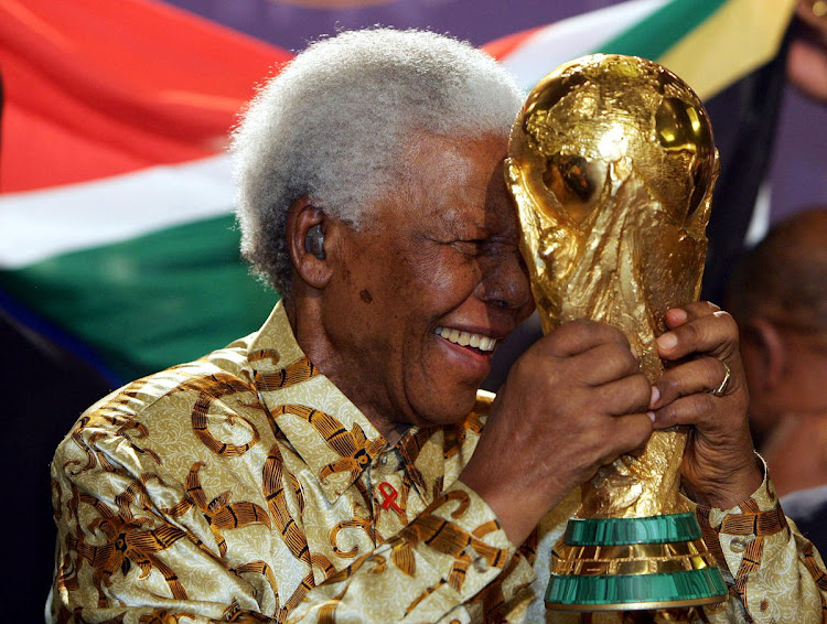 A file photo of the late former South Africa President Nelson Mandela holding the FIFA World Cup trophy.