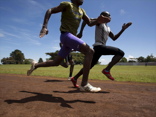 Athletes sprint during a training session on a dirt track in the town of Iten in western Kenya, November 13, 2015. Picture taken November 13, 2015. REUTERS