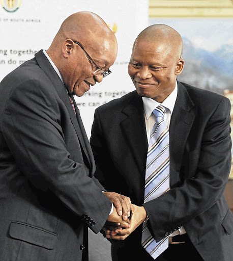 President Jacob Zuma congratulates Justice Mogoeng Mogoeng after appointing him as the new chief justice of South Africa at the presidential guest house in Pretoria yesterday. Picture: SIPHIWE SIBEKO/REUTERS