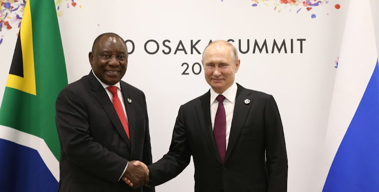 Russian President Vladimir Putin, right, greets President Cyril Ramaphosa at the G20 Osaka Summit 2019, in Osaka, Japan, in this 2019 file photo. Picture: MIKHAIL SVETLOV/GETTY IMAGES