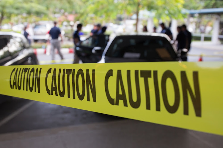 Police give their attention at a murder scene.