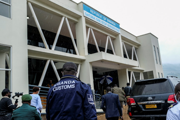 Delegates walk outside the Gatuna one-stop border post at Gicumbi, northern Rwanda, January 31, 2022.