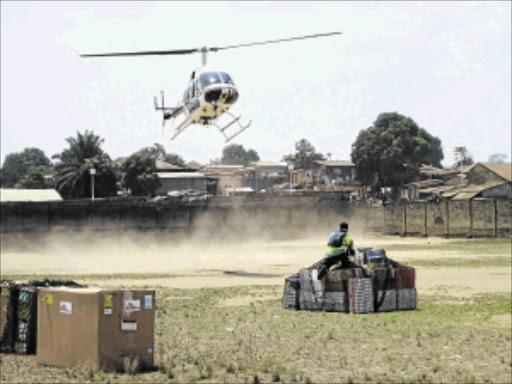 SPREAD OF DISEASE: A Samaritan's Purse team member helps with the delivery of supplies in Liberia. An isolation unit for ebola victims in Liberia's capital, Monrovia, is overrun with cases and health workers are being forced to treat up to 20 new patients in their homes, government officials said on Wednesday Photo: REUTERS/Samaritan's Purse