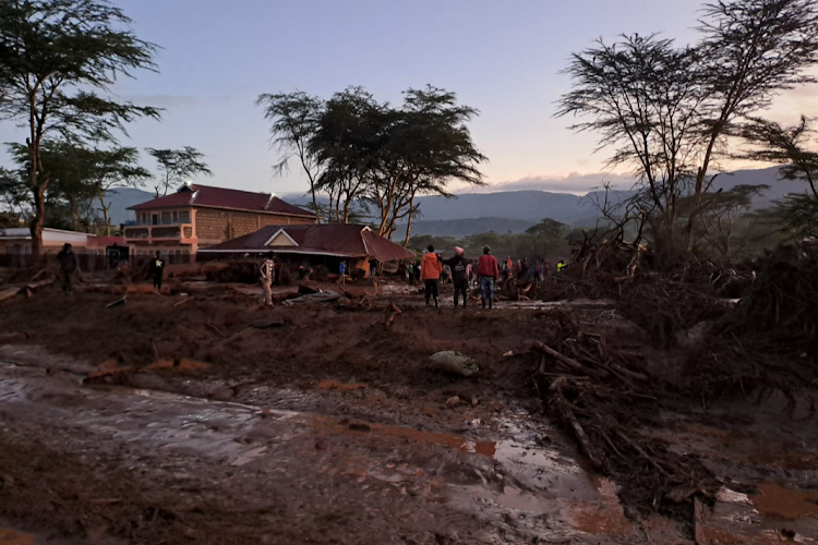 People inspect a house damaged by raging flood waters at Kamuchiri village in Mai Mahiu, Nakuru County on Aril 29, 2024.