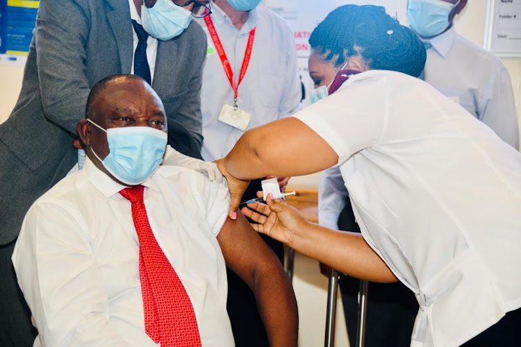 A nurse at Khayelitsha District Hospital injects President Cyril Ramaphosa with the Covid-19 vaccine on February 17 2021.