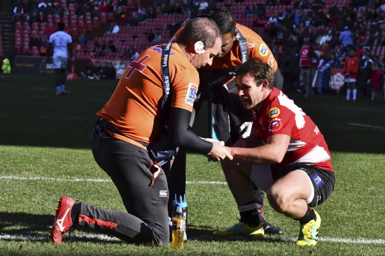 Nic Groom is attended to by the medical team after sustaining a hand injury during the Super Rugby match between Emirates Lions and Vodacom Bulls at Emirates Airline Park on July 14, 2018 in Johannesburg, South Africa.