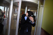 Former Parktown boys assistant water polo coach Colin Rex hides his face after leaving the high court sitting at the Palm Ridge Magistrate’s Court,  South of Johannesburg.  