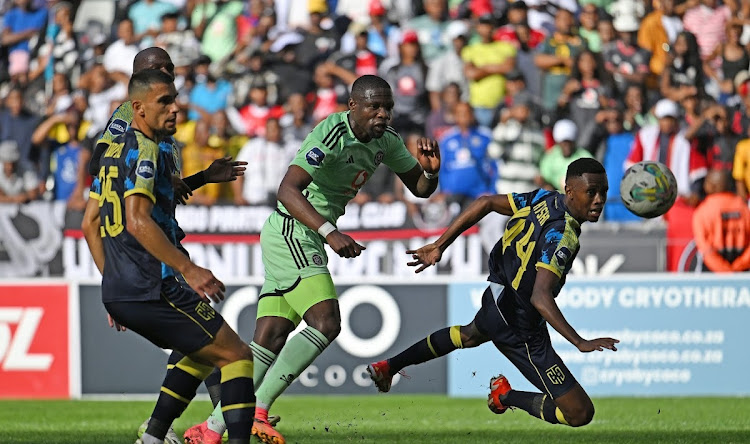 Pirates' two-goal hero Tshegofatso Mabasa, centre, shoots for goal as Lorenzo Gordinho and Luyolo Slatsha of Cape Town City look on in Wednesday's match at the Cape Town Stadium. Picture: BACKPAGEPIX/RYAN WILKISKY