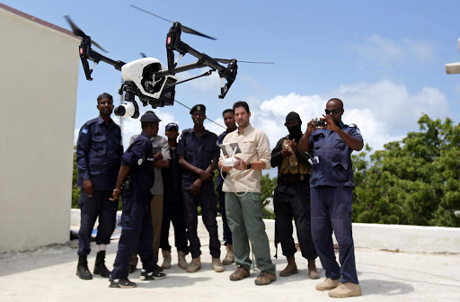 Somali police officers watch instructor Brett Velicovich fly a DJI Inspire drone during a drone training session for Somali police in Mogadishu, Somalia. REUTERS/Feisal Omar
