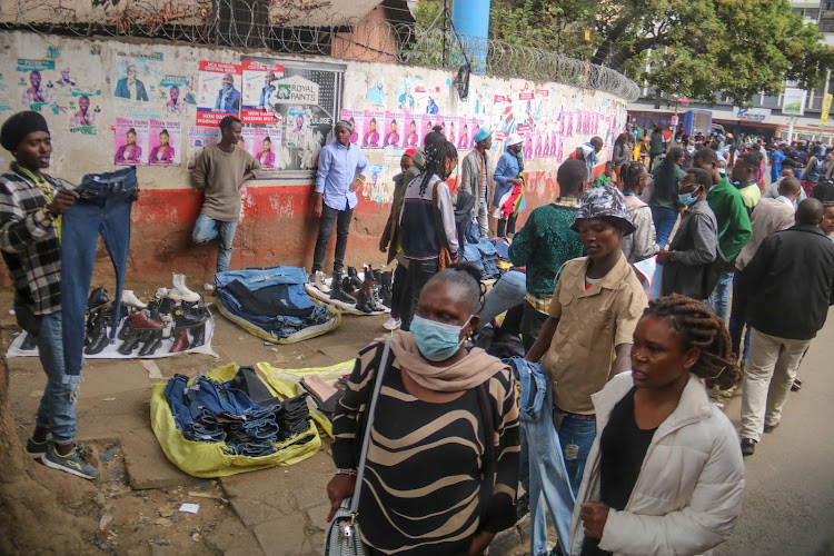 Hawkers sell their wares along a footpath on River Road.