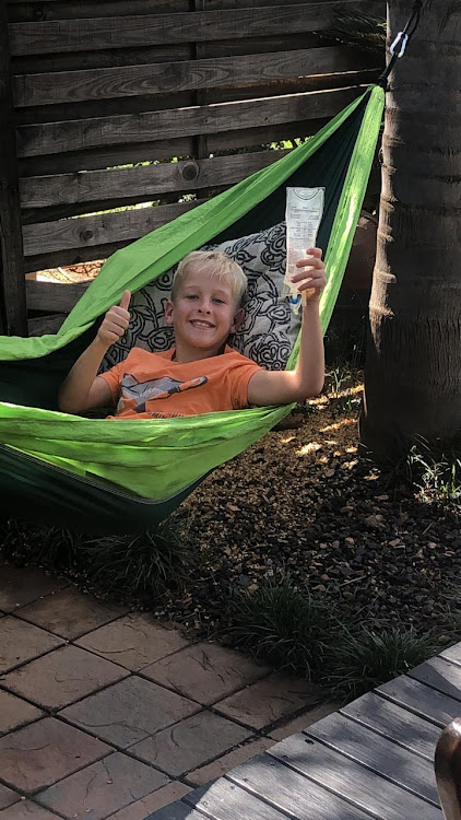 Juan du Plessis, 10, lives with Pompe, which affects his entire muscular-skeletal system, particularly his diaphragm and pulmonary system, receiving his medication while relaxing in a hammock at home during the Covid-19 lockdown.