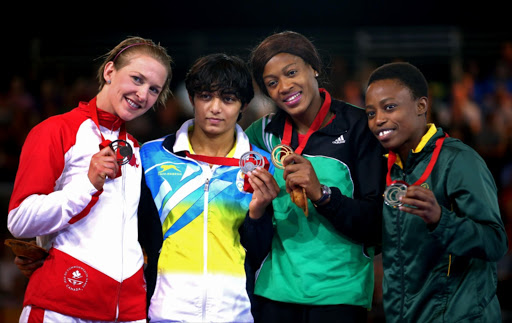 (L-R) Bronze medalist Jill Gallays of Canada, silver medalist Lalita Lalita of India, gold medalist Odunayo Adekuoroye of Nigeria and Mpho Madi of South Africa after the Women's 53kg wrestling at the Scottish Exhibition and Conference Centre during day seven of the Glasgow 2014 Commonwealth Games on July 30, 2014 in Glasgow, United Kingdom.