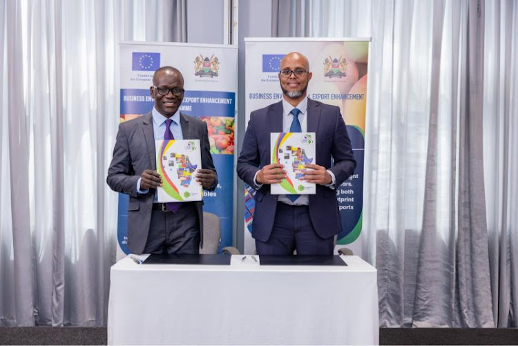 Clement Tulezi, Chairperson, National Horticulture Taskforce (L) and Ahmed Farah, Kenya Country Director, TradeMark Africa pose for a photo after signing the partnership agreement aimed at strengthening and sustaining trade and investment in Kenya's fresh produce exports