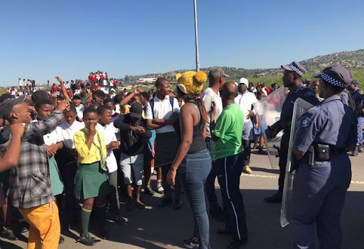 Kwamashu resident and students protesting through the streets .
