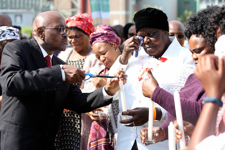 KwaZulu-Natal premier Willies Mchunu lights candles for the families who lost loved ones in the province during the recent floods.
