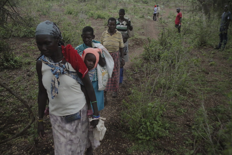 Women displaced by armed bandits walk home from a food-donation camp in Sibilo, Baringo North, on November 5, 2022.