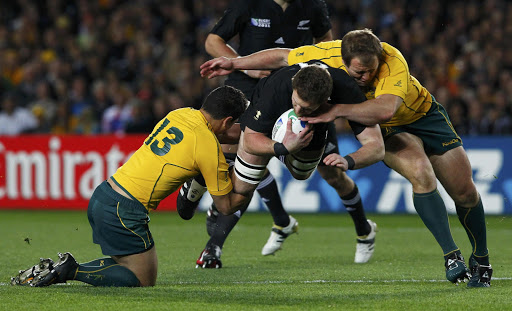 New Zealand All Blacks' Kieran Read (C) is tackled by Australia Wallabies' Anthony Faingaa (L). File photo