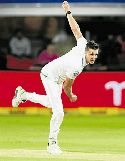 ON SONG: Proteas bowler Morné Morkel, left, celebrates the dismissal of Zimbabwean batsman Sikandar Raza during the second day of the day/night Test cricket match at St George’s Park Cricket Ground Picture: AFP