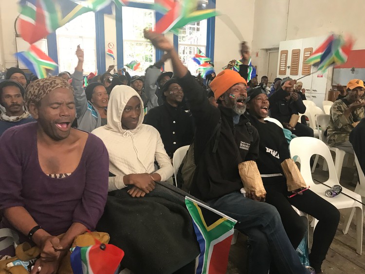 In Cape Town people cheer the Springboks at a soup kitchen.