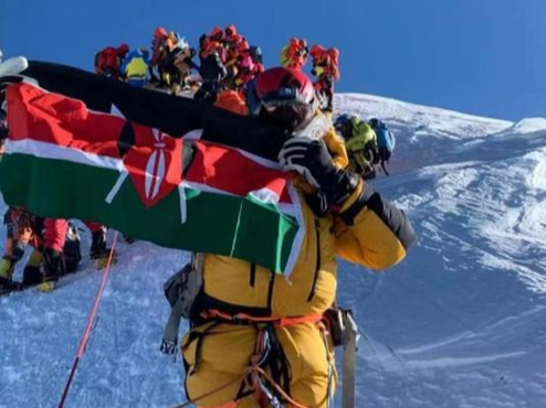 James Kagambi holding the Kenyan Flag when he reached the peak of Mt.Everest on Thursday, May 13,2022.
