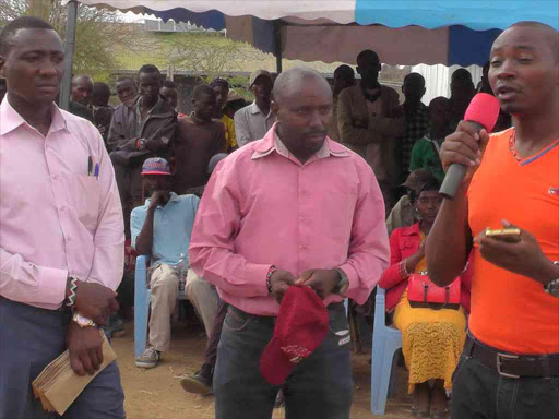 Maina Munene, a Meru-based businessman, in an Orange T-shirt, addressing players at Illpolei trading center on Sunday. He has caused jitters among Laikipia North leaders and politicians after he toured several areas in hired chopper though he has not declared his political interest.