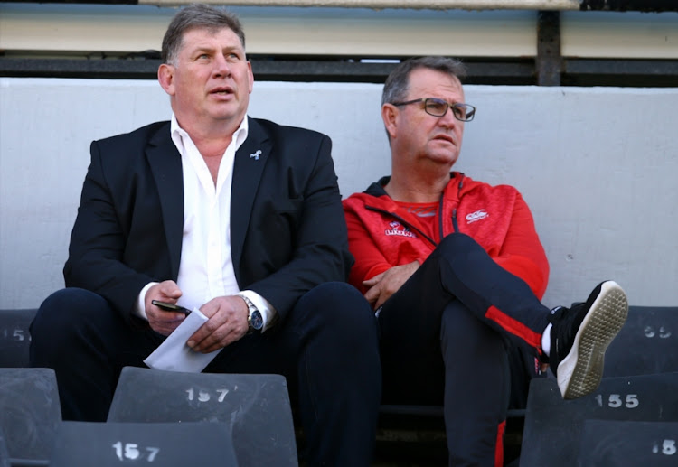 The Golden Lions chief executive Rudolf Straeuli (L) sits alongside the Lions' Super Rugby head coach Swys de Bruin (R) during the SuperSport Rugby Challenge match at Jonsson Kings Park Stadium on June 30, 2018 in Durban.