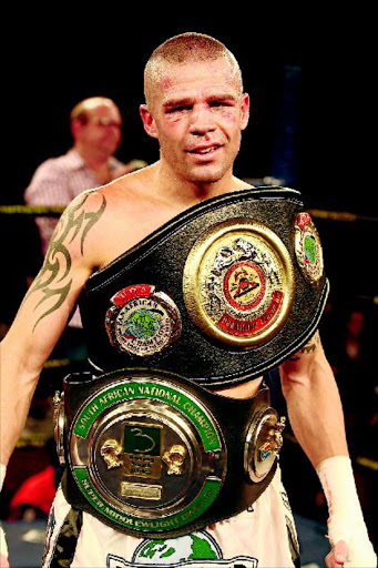 SWEET VICTORY: Warren Joubert shows off his belts after he defeated Grant Fourie at Emperors Palace on the East Rand PHOTO: ANTONIO MUCHAVE