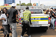 Protesters outside the Daveyton police station yesterday after a taxi driver was allegedly dragged by a police van and then beaten to death.